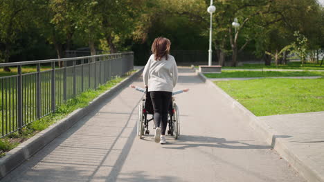 mother runs pushing child with disability in wheelchair