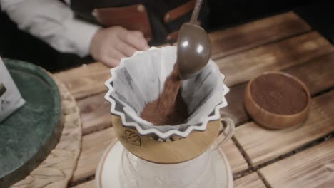 adding coffee grounds to the container or funnel where water is poured is a traditional method, creating a rich brew as the water extracts the coffee's essence