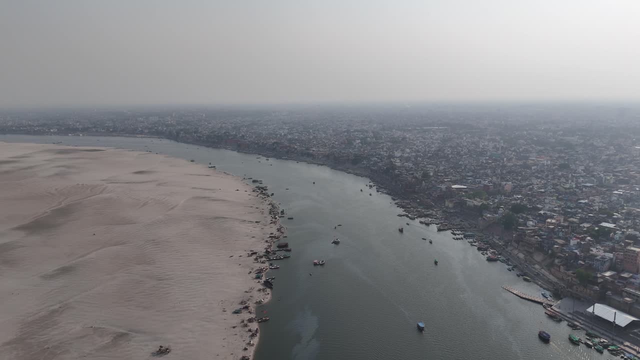 Overhead footage of a bustling Varanasi ghat, where the sacred meets the everyday, and rituals unfold against a backdrop of ancient stone steps.