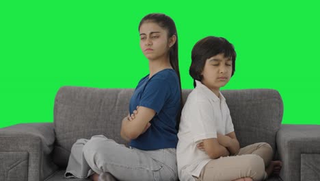 Angry-Indian-siblings-sitting-back-to-back-and-not-talking-Green-screen