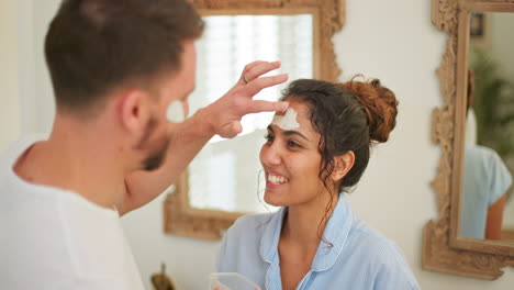 skin care, face mask and couple in home bathroom