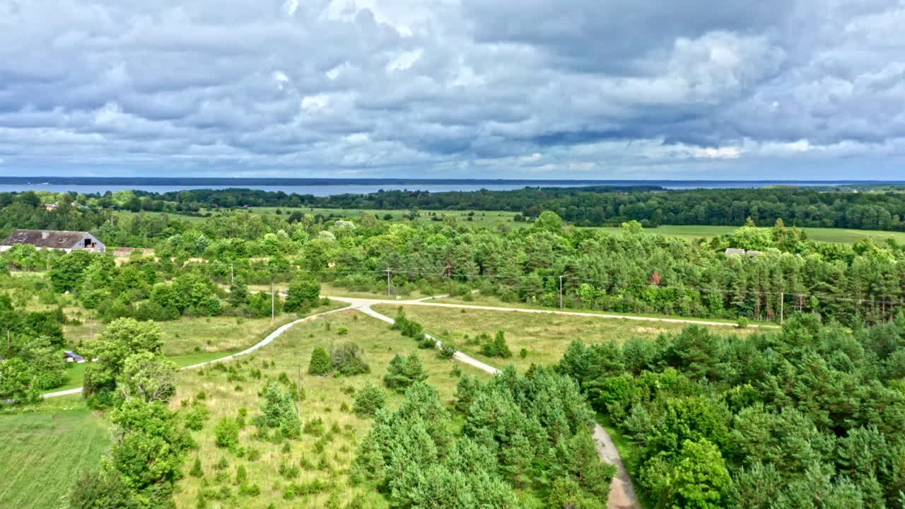 High-Level Aerial Flying Over Rural Landscape Towards the Sea - Dolly Shot