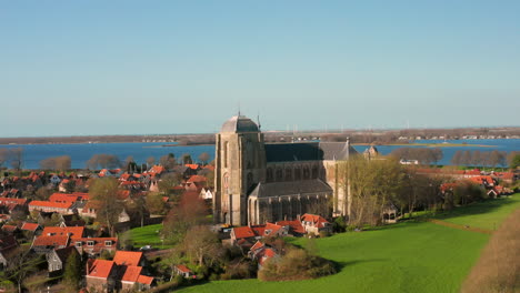 aerial: the historical town of veere with an old harbour and churches, on a spring day