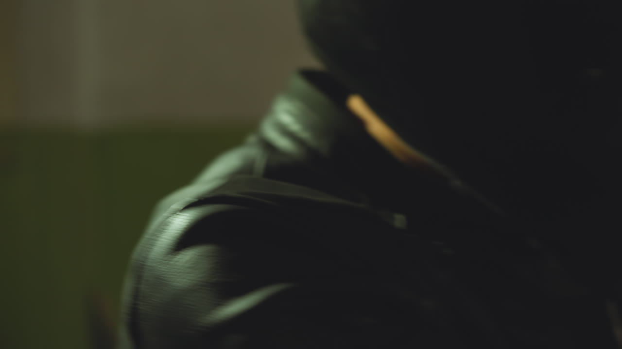 hombre armado en traje de moto negro casco prowls sosteniendo un arma