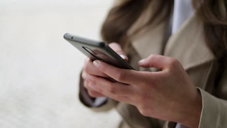 close up shot of caucasian female hands texting on phone