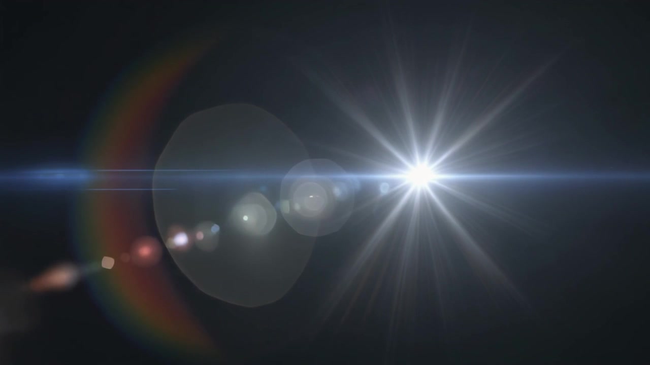 Bright White Lens Flare Moving Across Dark Background
