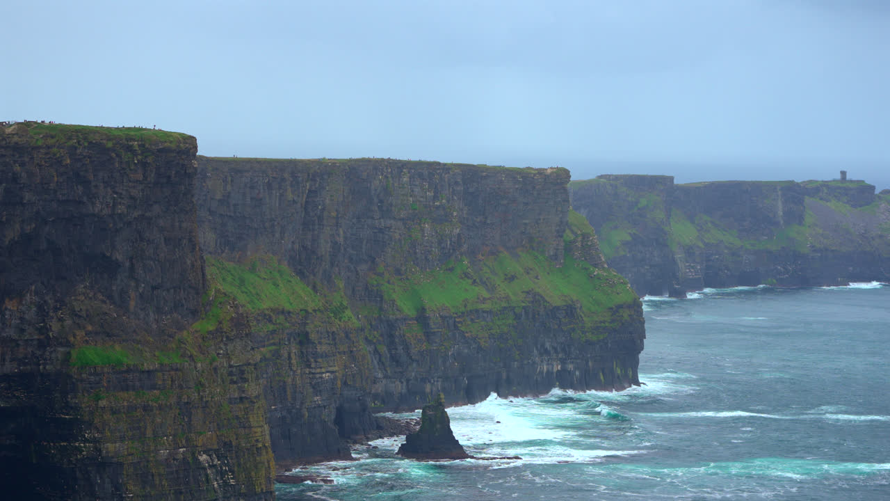 Ireland’s Cliffs of Moher rise high above the ocean, their sheer walls creating a breathtaking sight. The meeting of land and sea forms a striking display of raw natural power.