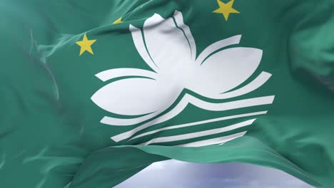 flag of macau waving at wind with blue sky in slow, loop