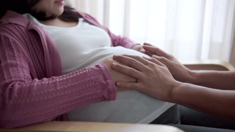 pregnant couple feels love and relax at home.