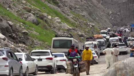 people waiting in cars, outside at a traffic blockade in a valley road, caused by land sliding, static shot, copy space