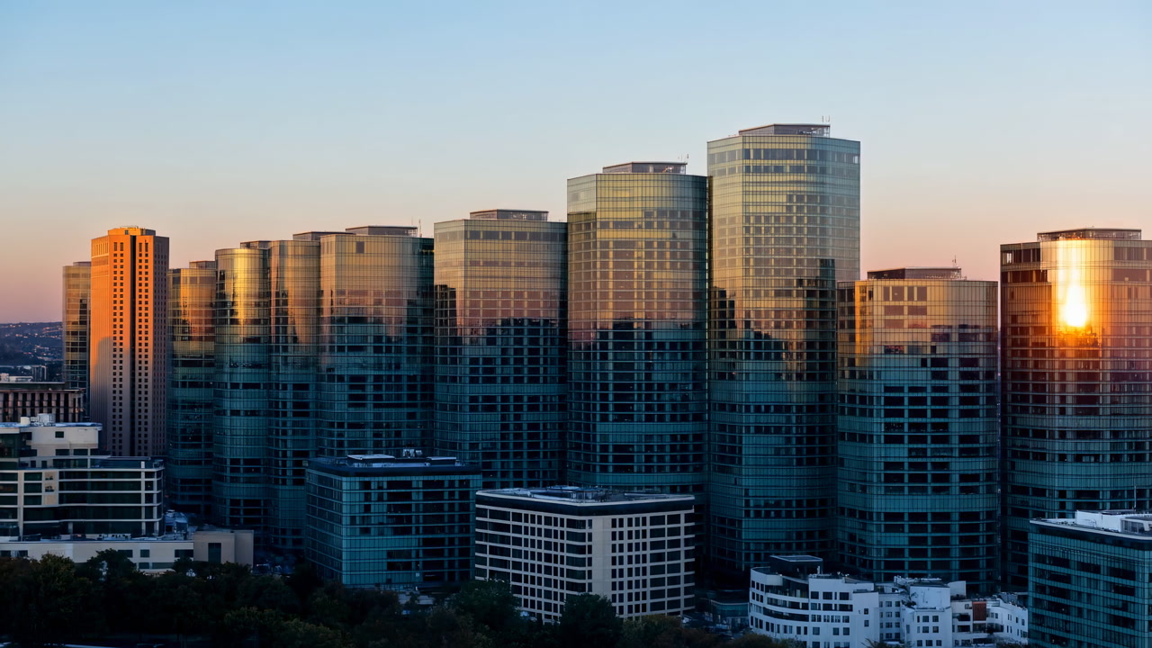 City Skyline At Night Into Sunrise, Glowing Office Windows, Glass Towers Reflecting Early Light, Calm Blue