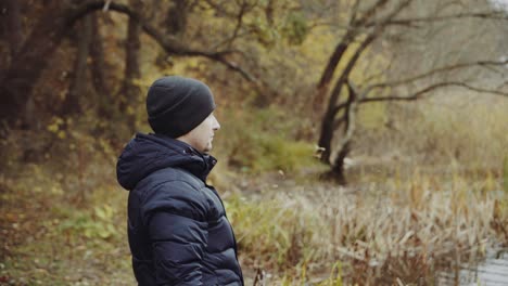 tourist with backpacks travel. tourist man with backpack on meadow in autumn forest