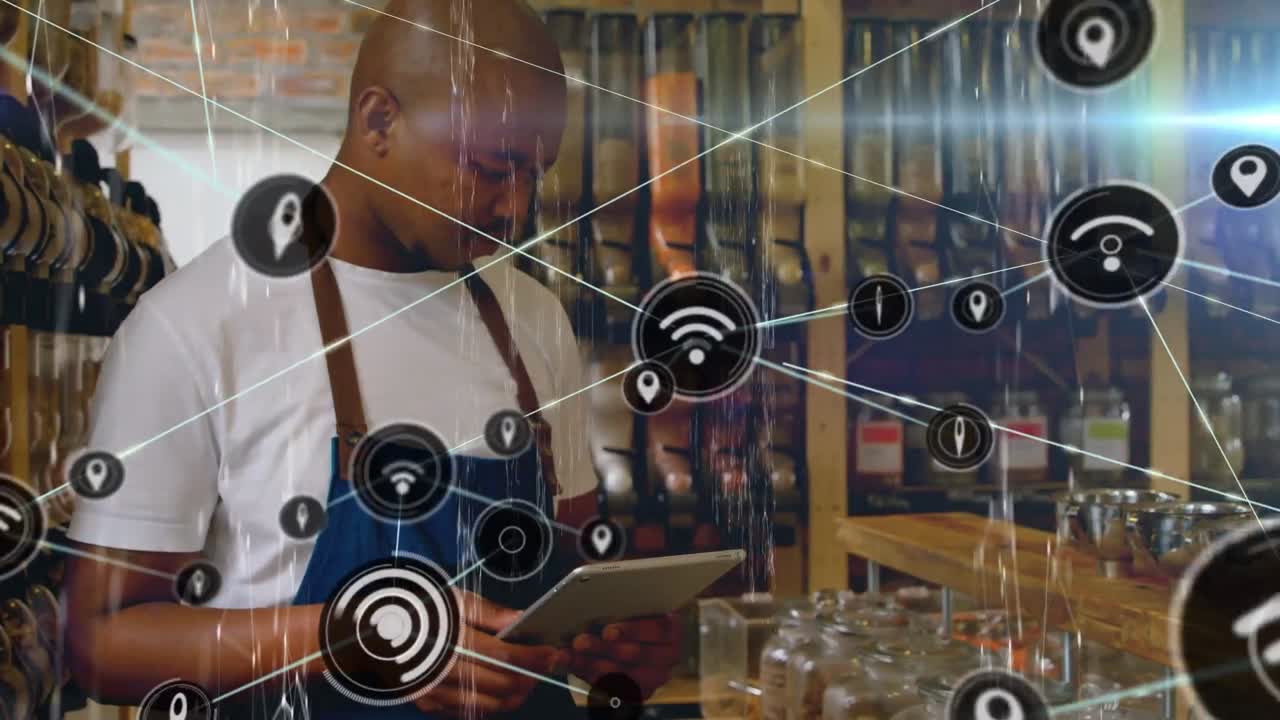Animation of network of connections over african american man using tablet
