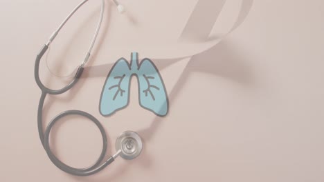 Animation-of-lungs-over-stethoscope-and-ribbon-on-pink-background