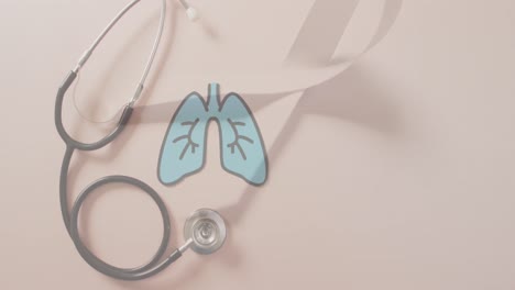 animation of lungs over stethoscope and ribbon on pink background