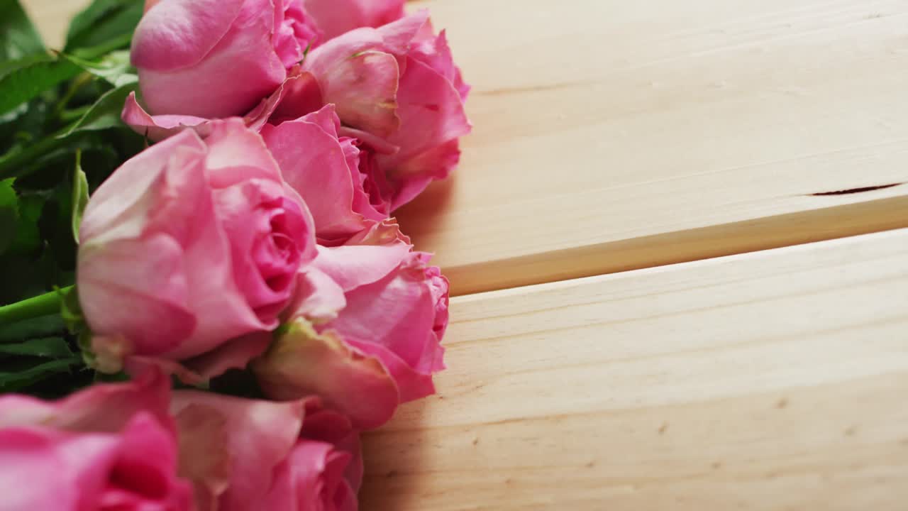 Bouquet of pink roses on wooden background at valentine's day