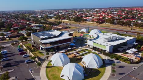 Fast-aerial-pull-back-to-reveal-white-dome-tents-and-picnic-benches-setup-ready-for-outdoor-event