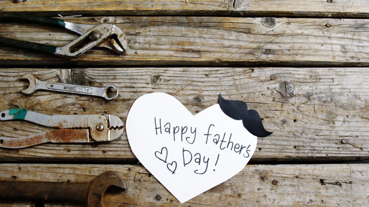 Happy fathers day card with old work tools on wooden plank