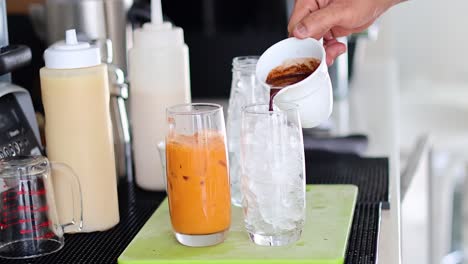 sequence of adding ice and coffee to a glass