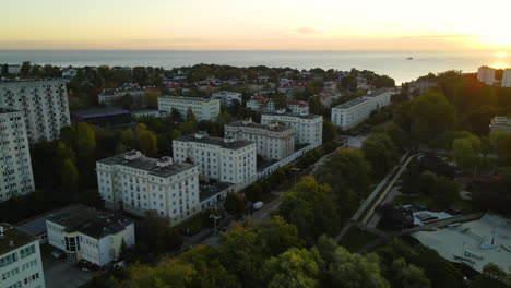 Gdynia-City-in-Poland---Aerial-View-Of-The-Beautiful-Buildings-With-Green-Trees-During-Sunset---Aerial-Shot