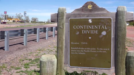 a sign indicates the location of the continental divide in america