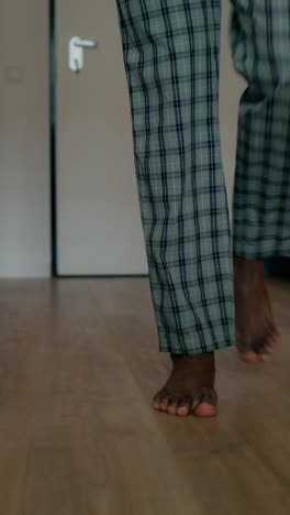 person walking barefoot in pajamas