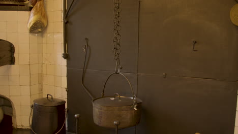 tilt up over old pan hanging above wood in old fashioned kitchen