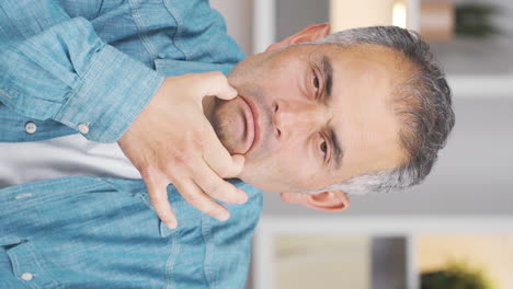 Vertical-video-of-Man-looking-at-camera-with-a-negative-expression.