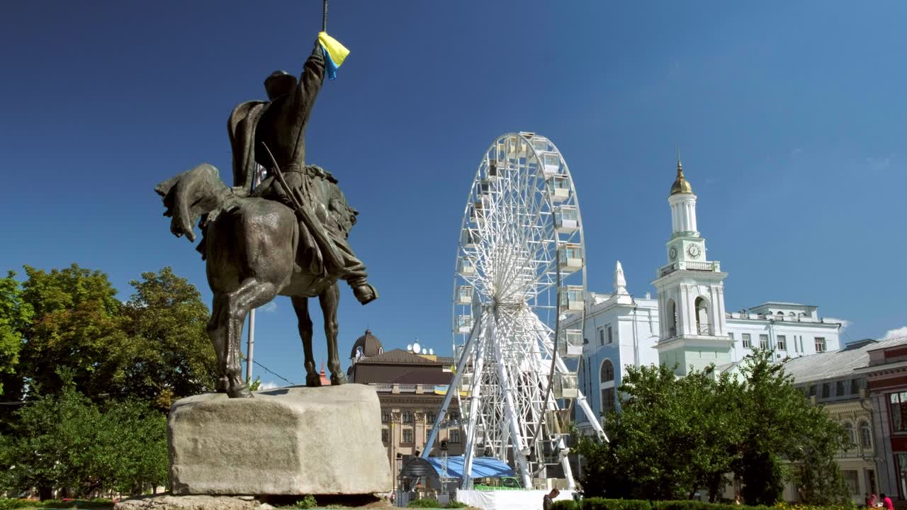 Low wide clip of Petra Sagaidachnogo statue with ferris wheel and St Catherines Church in Podil, Kiev