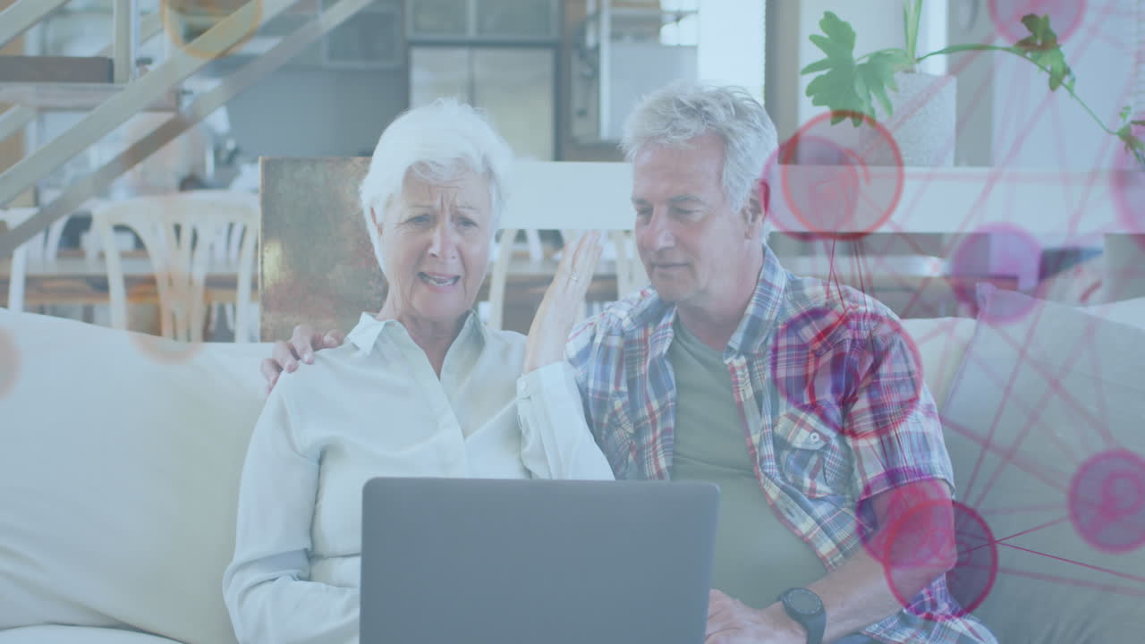 Animation of network of connections over senior caucasian couple using laptop