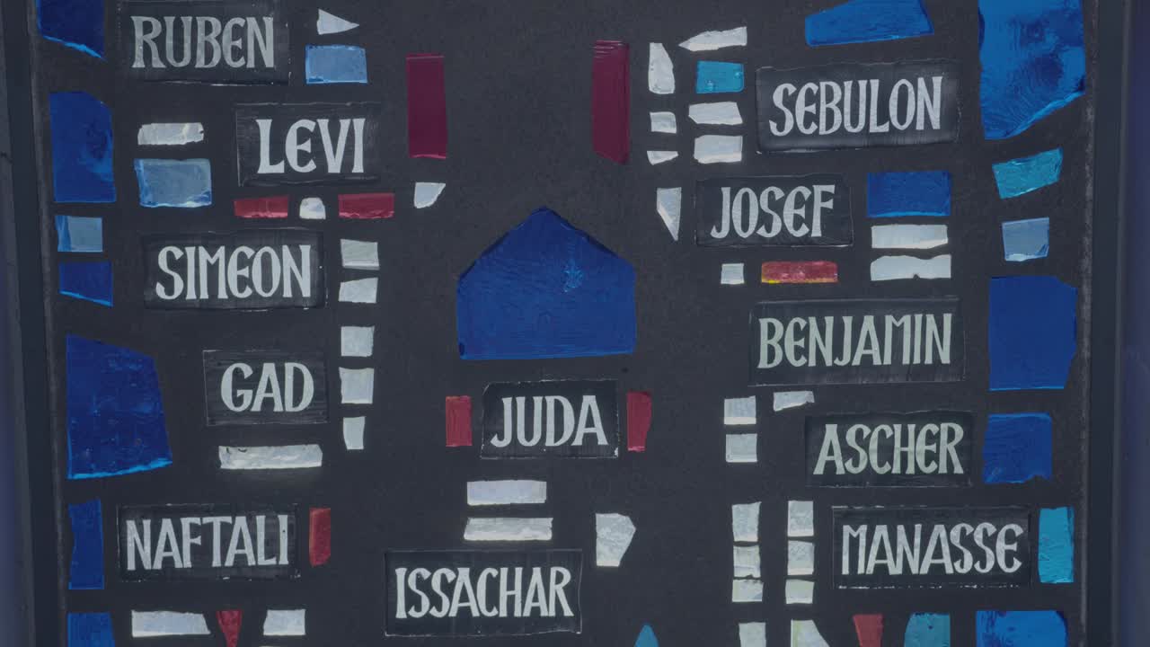 Camera pans along a glass mosaic with the twelve tribes of Israel