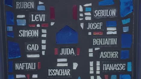 Camera pans along a glass mosaic with the twelve tribes of Israel