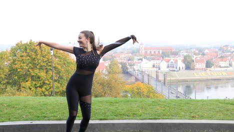 Close-up-of-a-female-dancer-dancing-outside-in-a-sunny-city