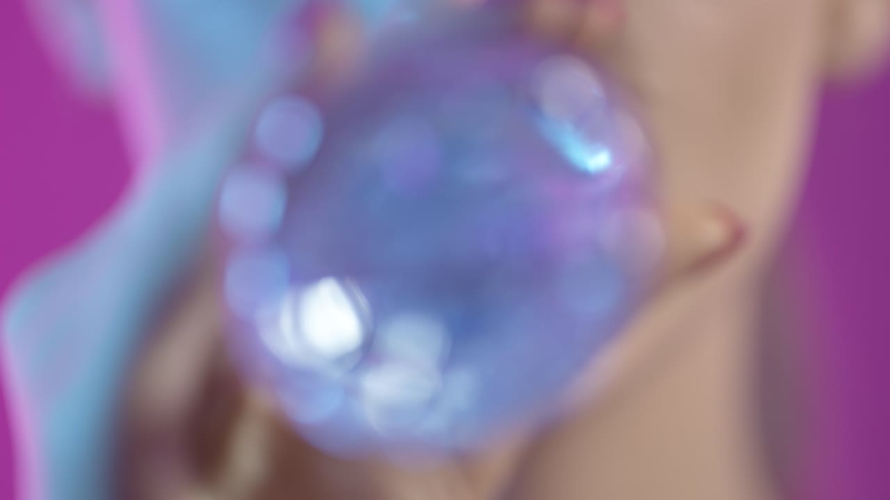 woman taking a sip of water from waterbottle in close-up, girly nail polish and red lipstick lips on purple background