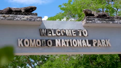 closeup of welcome to komodo national park entrance with komodo dragons at popular tourism destination, komodo island, lesser sunda islands of indonesia