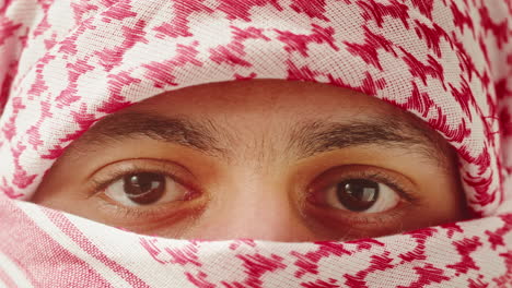 close-up portrait of a man wearing a keffiyeh