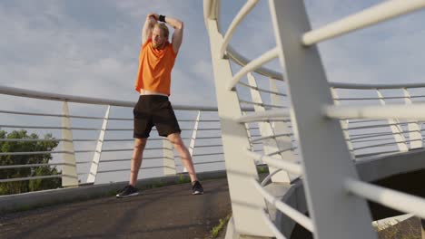 sporty caucasian man training on a bridge