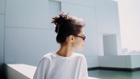 woman in sunglasses outside modern building