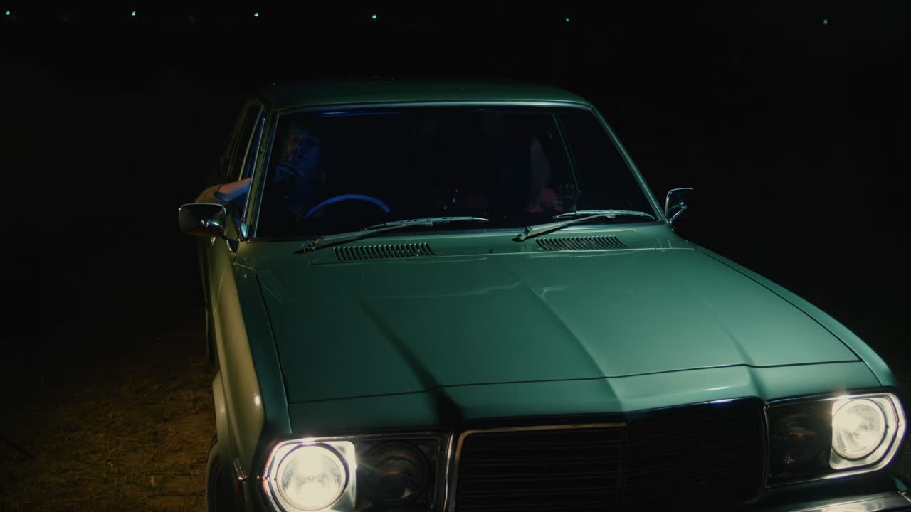 Vintage Green Car at Night