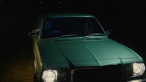 vintage green car at night