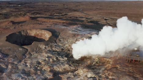 gunnuhver geyser spraying out steam, geothermal landscape in iceland