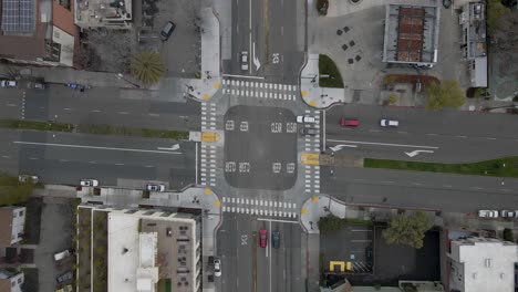 Captured-from-a-top-down-perspective-on-a-tranquil,-post-rain-Saturday-morning,-this-static-drone-shot-offers-a-unique-view-of-the-intersection-at-University-and-Sacramento-Street-in-Berkeley,-CA