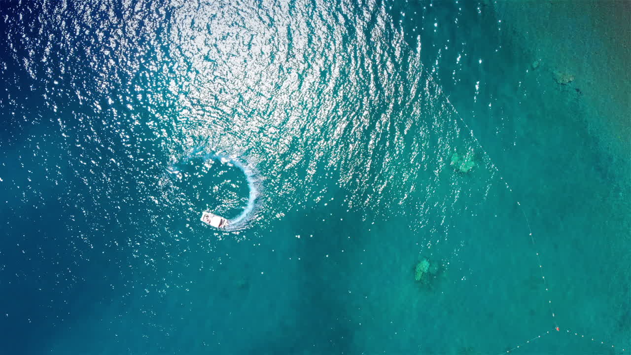 Aerial footage over circle and spiral shape made with foamy speedboat