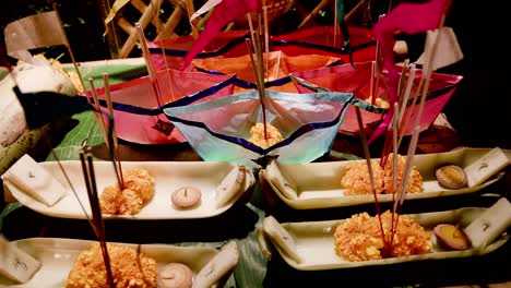 group of colorful floating sapao or decorated baskets made of banana stalk used during loi krathong festival in chiang mai, thailand to pay respect to water spirit