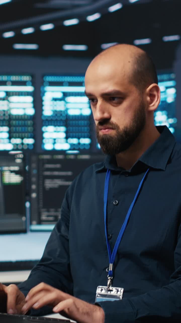 Focused IT Professional Typing on Keyboard in Data Center
