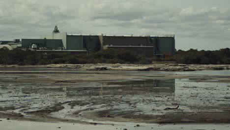 Sulfur-flats-near-lake-Rotorua-with-a-building-on-the-horizon-in-New-Zealand