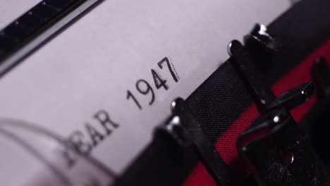 year 1947, typing on white paper in vintage typewriter, macro close up