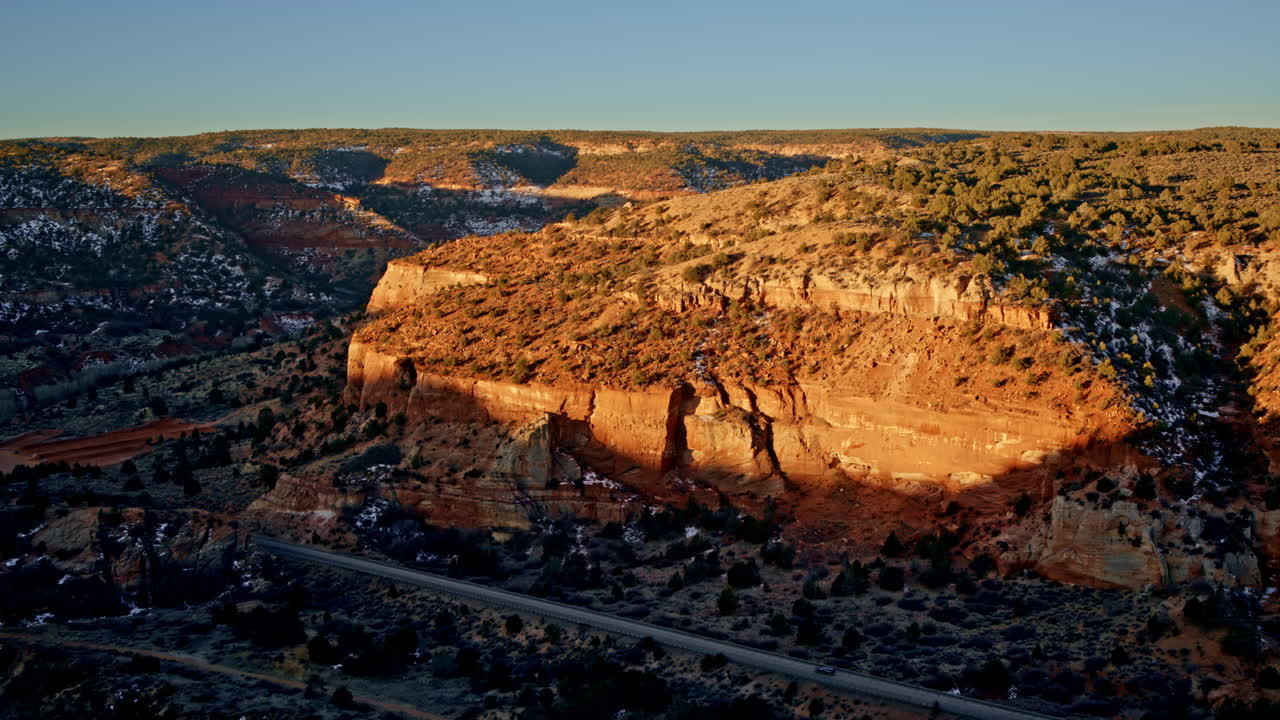 Expansive aerial footage of the Canyonlands near Kanab, Utah, as dawn breaks over the horizon.