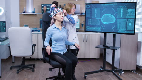 woman wearing brainwave scanning headset sitting on a chair