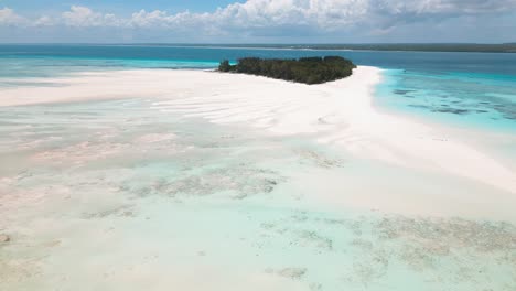 4k flying drone footage above white sandbanks coast with beautiful transparent rippled waves washing coral reefs atoll near mnemba island, tanzania